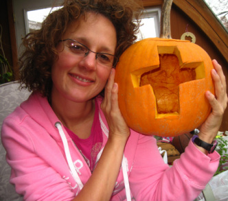 Should Christians celebrate Halloween? Photo of Debra Torres holding a pumpkin with a cross carved in.